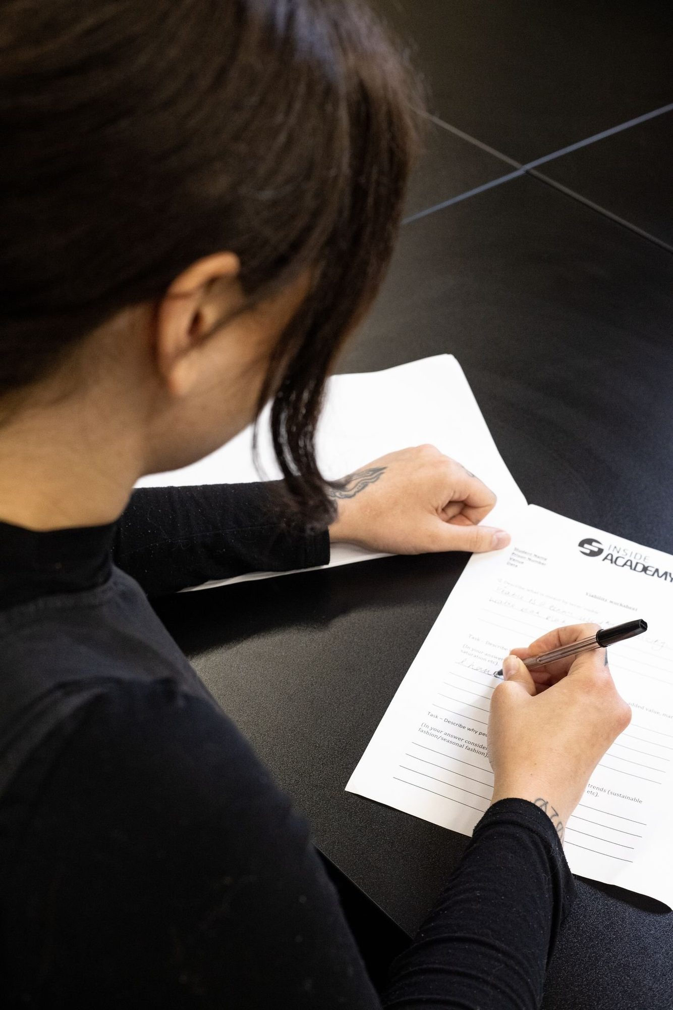 A learner completing an Inside Academy worksheet
